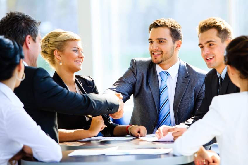 business people shaking hands across a table