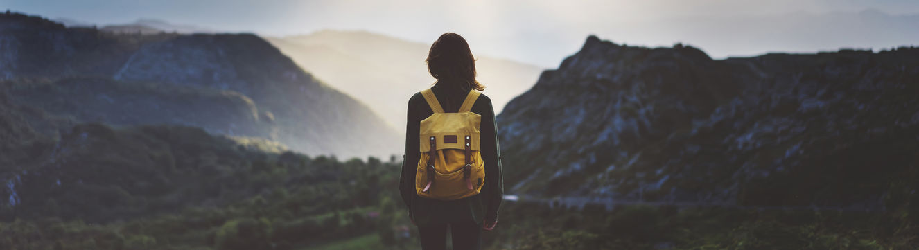 hiker looking at mountain sunset