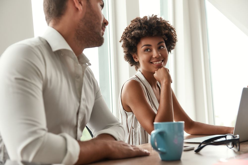 two office colleagues talking